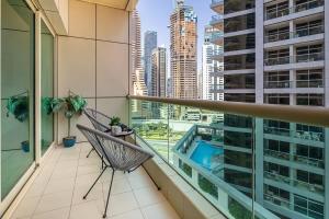 a balcony with a chair and a view of a city at Frank Porter - Royal Oceanic in Dubai