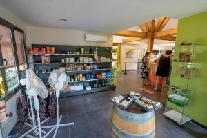 a room with a store with people standing in it at Glamping Lac du Causse in Lissac-sur-Couze
