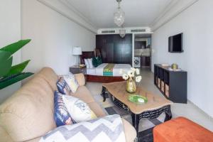 a living room with a couch and a bed at Frank Porter - Goldcrest Views in Dubai