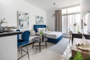 a hotel room with a bed and a living room at Frank Porter - Botanica Tower in Dubai