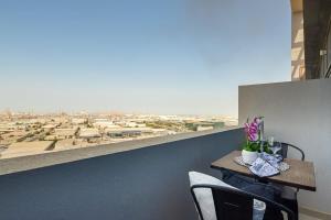 a table and chairs with a view of a city at Frank Porter - Azizi Aura in Dubai