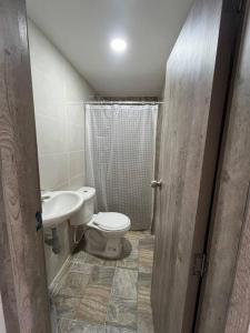 a small bathroom with a toilet and a sink at Apto 301 cerca a C.C. unicentro in Cúcuta