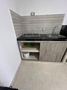 a small kitchen with a sink and a counter at Apto 301 cerca a C.C. unicentro in Cúcuta