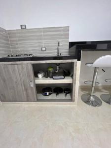 a kitchen with a sink and a stool in a room at Apto 301 cerca a C.C. unicentro in Cúcuta