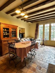a living room with a table and a couch at Le Vieux Manoir in Amboise