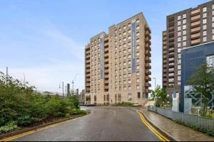 an empty street with two large tall buildings at Stylish & Spacious 1 Bed Apartment in Barking