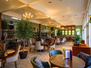 a restaurant with tables and chairs and a bar at Lochgreen House Hotel & Spa in Loans