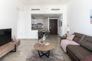 a living room with a couch and a table at Frank Porter - Majestique Residence 2 in Dubai