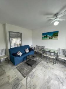 sala de estar con sofá azul y mesa en Appartement Penthouse II 15 - 5, en Mijas Costa