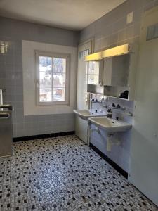 baño con 2 lavabos y ventana en Casa Mia Goms, en Reckingen - Gluringen