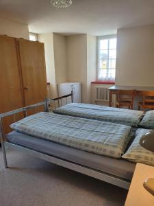 a bedroom with two beds and a table and chairs at Casa Mia Goms in Reckingen - Gluringen