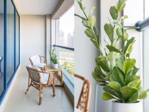 a room with a chair and a plant at Frank Porter - X1 Tower in Dubai