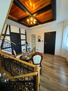 a living room with a staircase and a chandelier at Pokoje Gościnne u Reni in Wambierzyce +36 photos