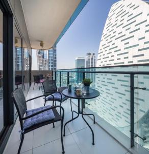 a balcony with a table and chairs on a building at Frank Porter - Merano Tower in Dubai