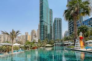 a large swimming pool in a city with tall buildings at Frank Porter - The Address JBR in Dubai