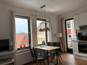 a kitchen and dining room with a table and chairs at Ferienwohnung Daisy in Sankt Andreasberg