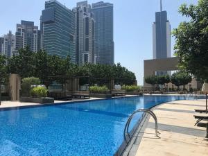 a large swimming pool with a city skyline in the background at Frank Porter - Boulevard Heights in Dubai