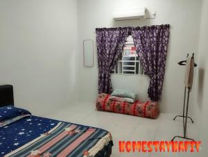 a bedroom with a bed and a window at Homestay Hafiy Manjung Lekir Sitiawan in Lekir