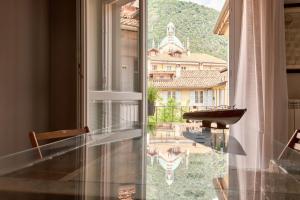 a room with a window with a view of a building at 21 Lake Sweet Home in Como