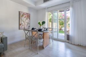 a dining room with a table and chairs and a window at Frank Porter - Springs 12 in Dubai