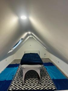 a room with a mattress on the floor in a attic at Ivory Penthouse Next to Wembley Stadium by Imperia Stays in London