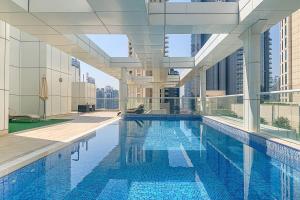 a large swimming pool in a building with a building at Frank Porter - Mon Reve in Dubai