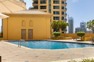 a swimming pool in front of a building at Frank Porter - Shams 4 in Dubai