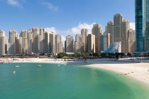 a beach in front of a city with tall buildings at Frank Porter - Shams 4 in Dubai