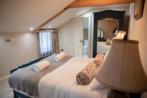 a bedroom with two beds and a large mirror at The Stables in Longwitton