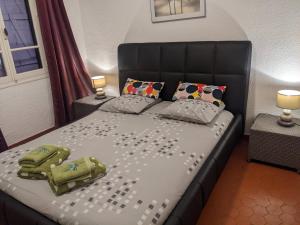 a bedroom with a bed with a black headboard and pillows at Prime Rose in Saint-Aygulf +50 photos