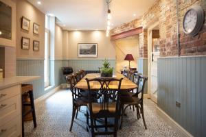 - une cuisine et une salle à manger avec une table et des chaises dans l'établissement The Stables, à Longwitton