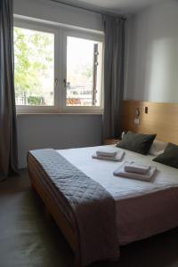 a large bed in a room with a window at Bed and Bike Verona in Verona