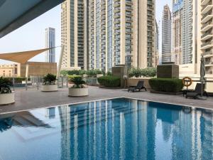a large swimming pool in a city with tall buildings at Frank Porter - 8 Boulevard Walk in Dubai