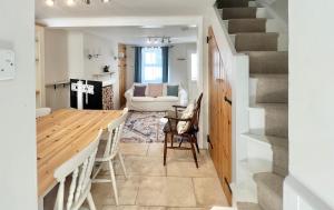 a kitchen and dining room with a table and chairs at Farthing Cottage…cute ‘n’ cosy! in Kingsbridge