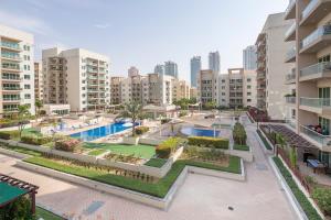 an apartment complex with a swimming pool and buildings at Frank Porter - Al Samar in Dubai