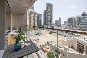 a balcony with a vase on a table in a city at Frank Porter - Boulevard Point in Dubai