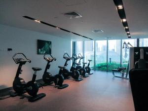 a row of exercise bikes in a fitness room at Frank Porter - Boulevard Point in Dubai
