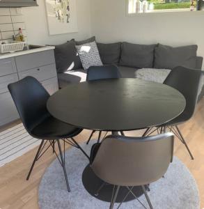 a black table and chairs in a living room at Paradise House in Motala