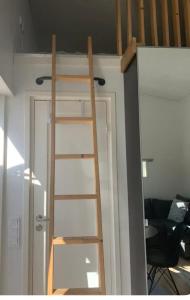 a ladder leading up to a loft bed in a room at Paradise House in Motala