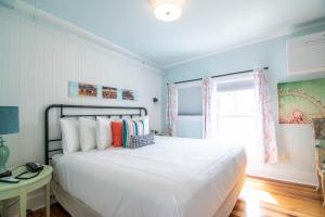a bedroom with a large white bed and a window at Ocean House Hotel & Motel in Old Orchard Beach