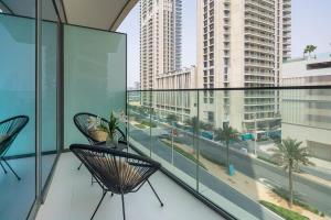 een balkon met 2 stoelen en uitzicht op de stad bij Frank Porter - Beach Vista Tower 1 in Dubai