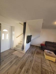 a living room with a couch and a staircase at Mara village house in Vrlika