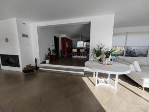 a living room with a white table and a white couch at La Lumineuse in Flayosc