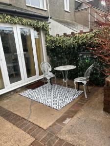 a patio with a table and two chairs and a table at On The Common in Cardiff