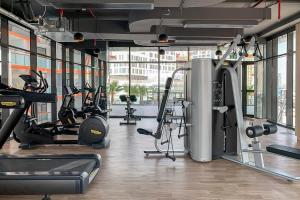 a gym with treadmills and exercise equipment in a building at Frank Porter - Binghatti Avenue in Dubai
