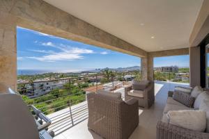 a living room with a view of the ocean at Spacious New 3BR Condo at Tramonti plus Resort Access in Cabo San Lucas