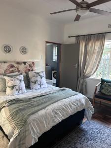 a bedroom with a bed and a ceiling fan at Lielies Guesthouse in Parys