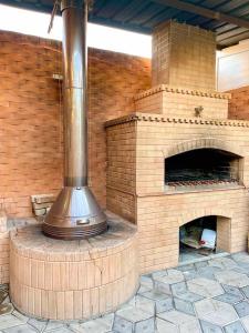 an outdoor brick oven with a brick wall at Argavand home in Yerevan