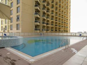 an empty swimming pool in front of a building at Frank Porter - Damac Crescent A in Dubai