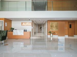 a lobby of an office with aania sign on the wall at Frank Porter - Azizi Aura in Dubai